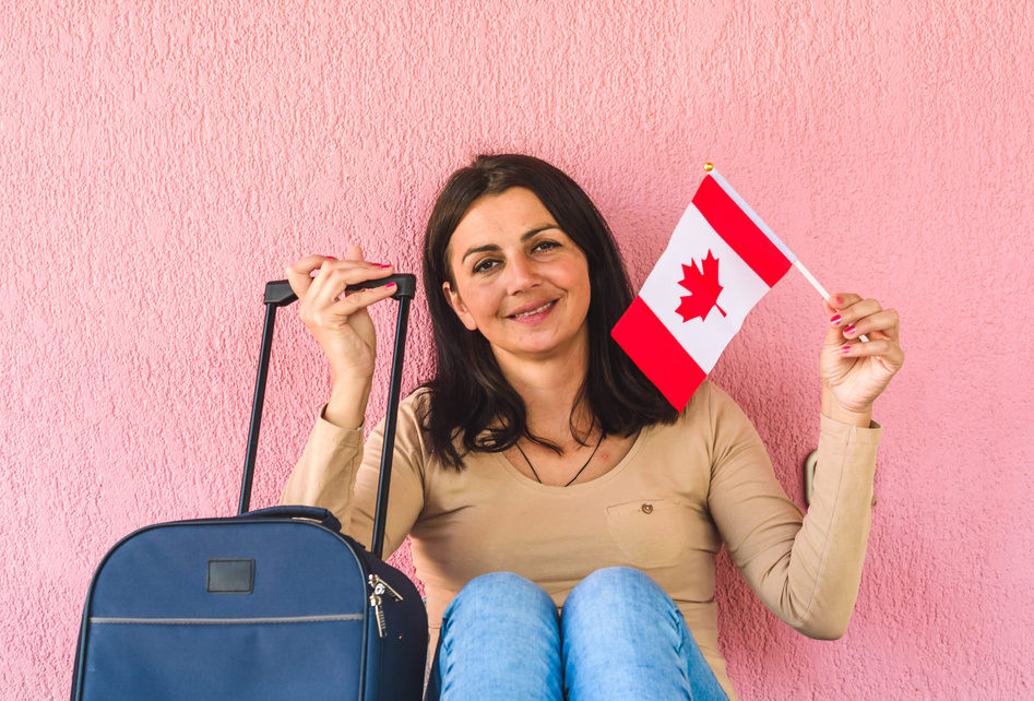 Woman with travel bag and flag of Canada